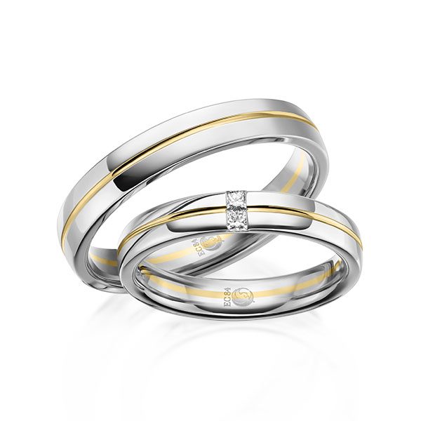 Elegante Trauringe in Palladium und Gelbgold mit klarer Bicolor-Optik, feinem Brillantakzent und moderner, ausgewogener Wirkung.