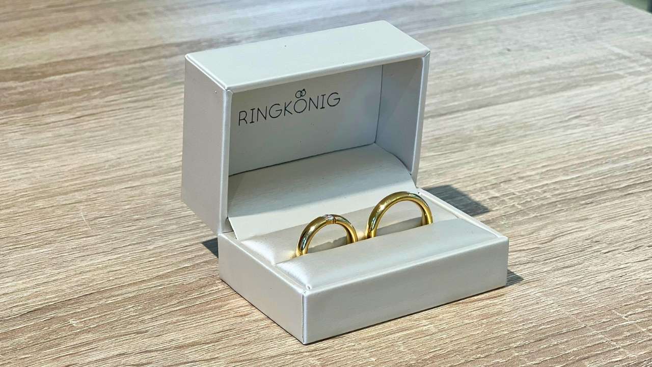 Trauringe kaufen im RINGKÖNIG Wermelskirchen bei Köln und Bergisch Gladbach. Ein Ringetui oder Schmuckkästchen mit zwei goldenen Ringen in 750ger Gold mit Brillanten.